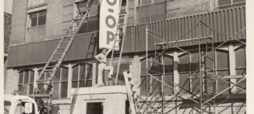 Installing new signs, Central Cooperative Wholesale Records, im111739, Box 40, IHRCA426, Immigration History Research Center Archives, University of Minnesota.